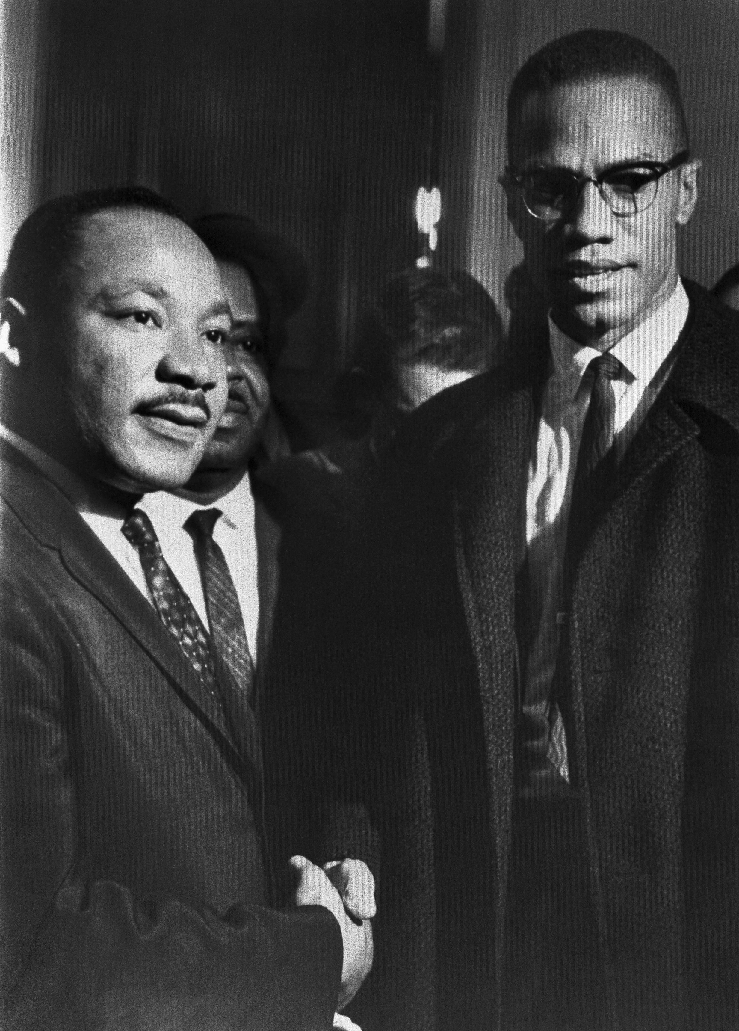 The brief, and only, meeting between Malcolm X (1925-1965) and Martin Luther King (1929-1968), in the halls of the US Capitol, attending a Senate hearing on the Civil Rights Act, Washington DC, 26th March 1964. | Source: Getty Images