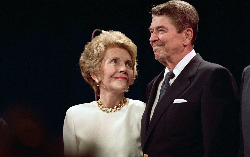 Nancy Reagan looks up at her husband, President Reagan, with loving eyes as he makes a surprise visit to a party in Nancy's honor here 8/15, in New Orleans, 1988. | Source: Getty Images