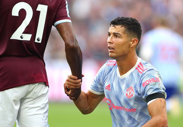 Christiano Ronaldo of Manchester United holds the hand of Angelo Ogbonna of West Ham United during the Premier League match between West Ham United and Manchester United at London Stadium on September 19, 2021 in London, England.