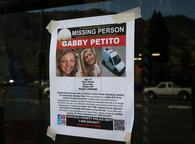 This Thursday, Sept. 16, 2021, photo, shows a Suffolk County Police Department missing person poster for Gabby Petito posted in Jakson, Wyo. Petito, 22, vanished while on a cross-country trip in a converted camper van with her boyfriend.