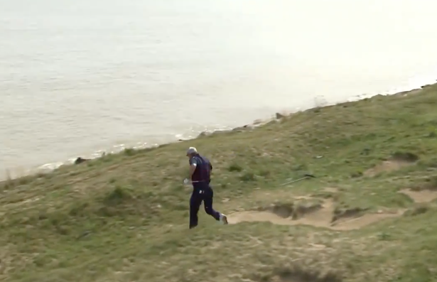Spieth played the shot but the momentum took him backwards towards Lake Michigan