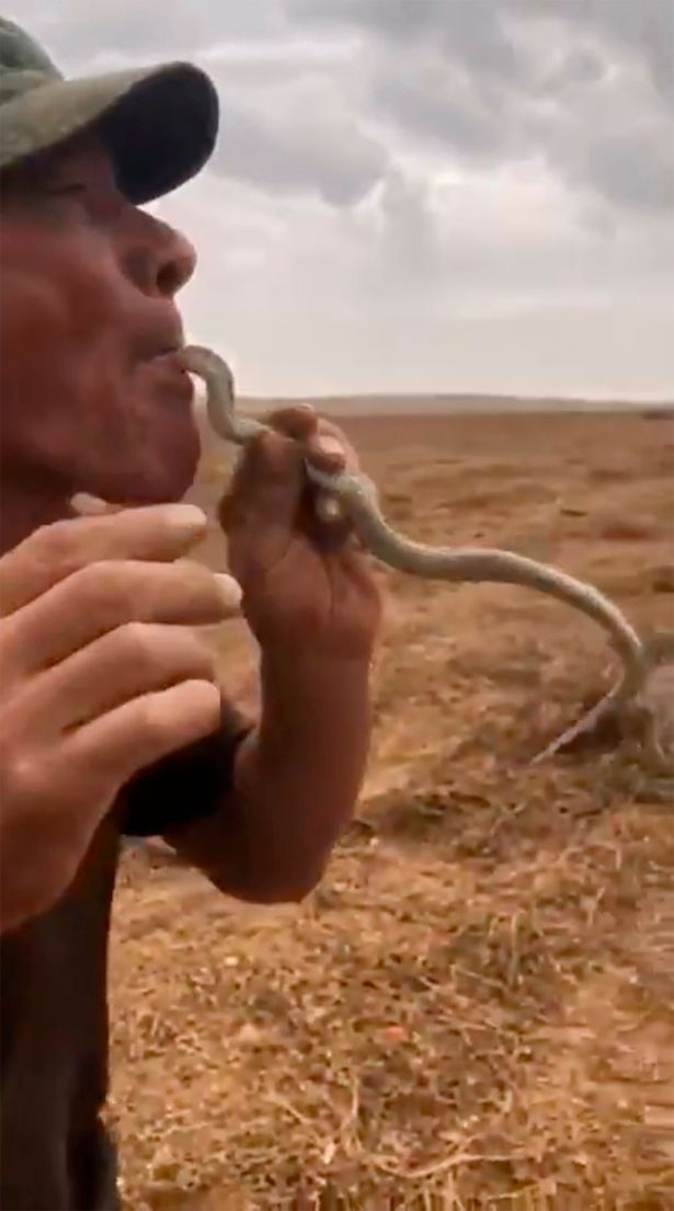 Man with the snake in his mouth