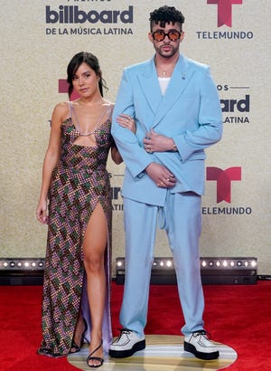 Bad Bunny, right, and Gabriela Berlingeri arrive at the Billboard Latin Music Awards on Thursday, Sept. 23, 2021, at the Watsco Center in Coral Gables, Fla. (AP Photo/Marta Lavandier) ORG XMIT: FLDA422