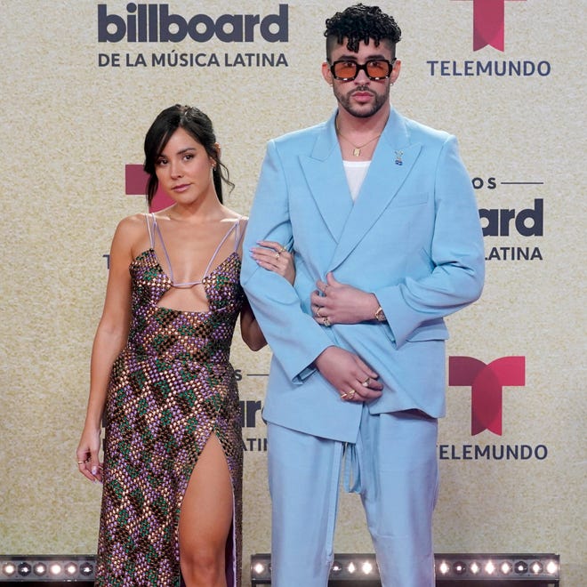 Bad Bunny, right, and Gabriela Berlingeri arrive at the 2021 Billboard Latin Music Awards, where the Puerto Rican rapper won 10 awards. He's up for four Latin Grammy awards, including album of the year.