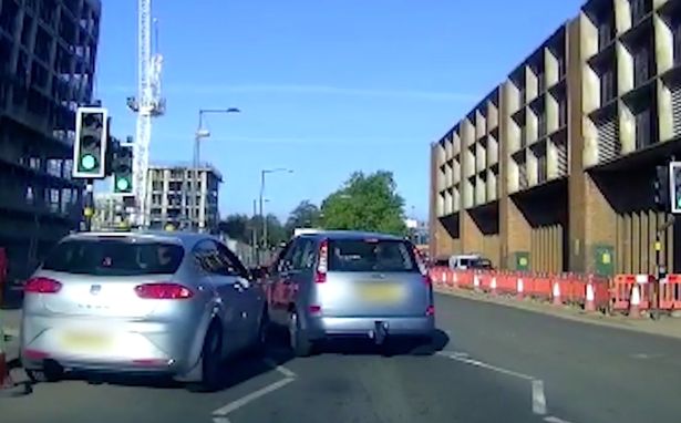 The woman got out of her car after the other driver tried to overtake her