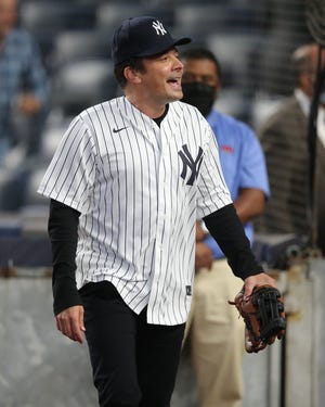 Jimmy Fallon takes the field at Tuesday's game between the New York Yankees and Texas Rangers at Yankee Stadium.