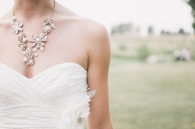 A woman in a wedding dress and necklace. | Source: Pexels