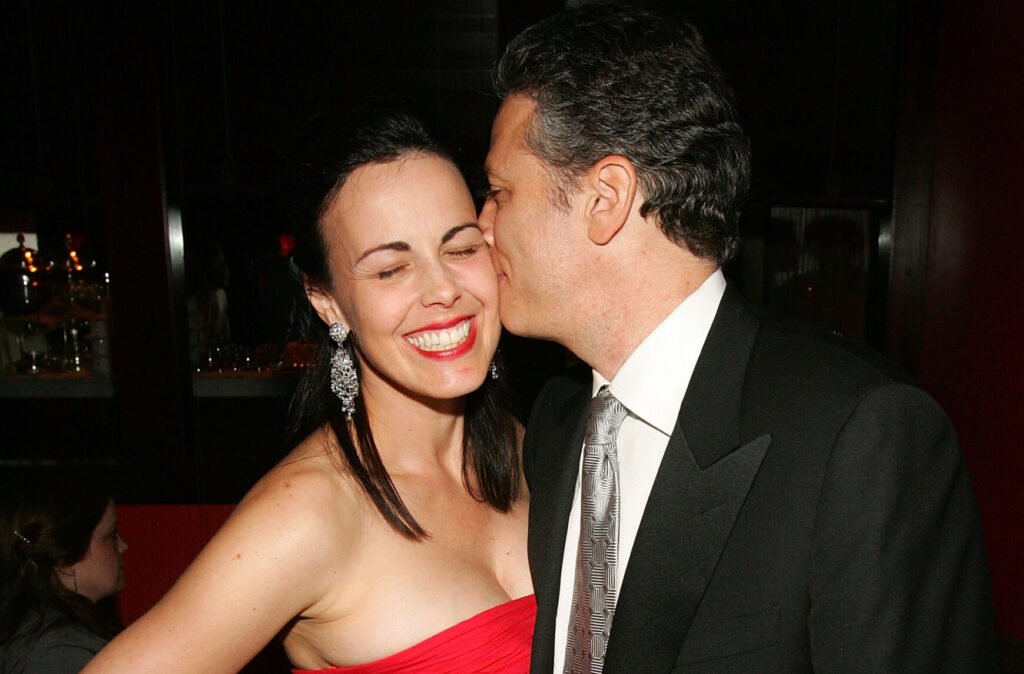 Jon Stewart kissing his wife, Tracey Stewart, on the cheek