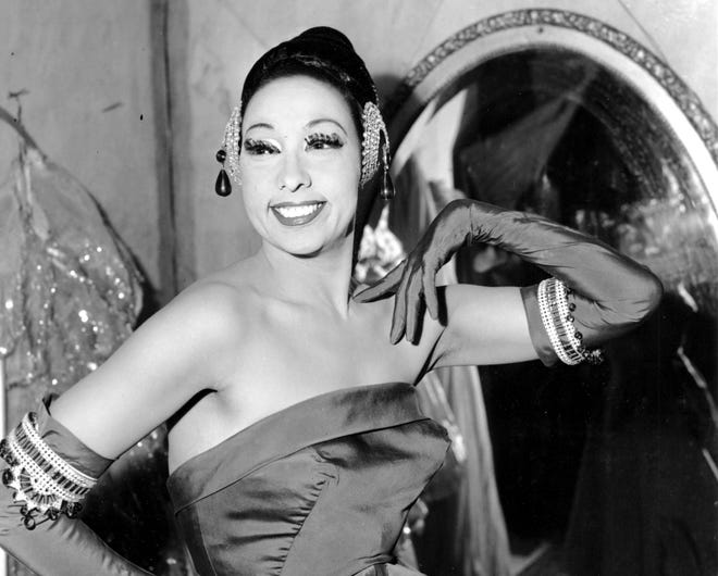 In this file photo dated March 6, 1961, singer Josephine Baker poses in her dressing room at the Strand Theater in New York City.