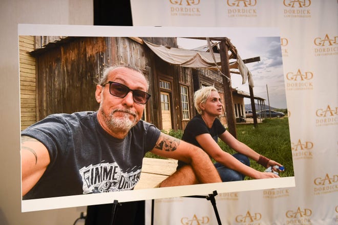 A photo of Serge Svetnoy and Halyna Hutchins is displayed after a news conference about Svetnoy's lawsuit filed following the fatal shooting on the film "Rust."