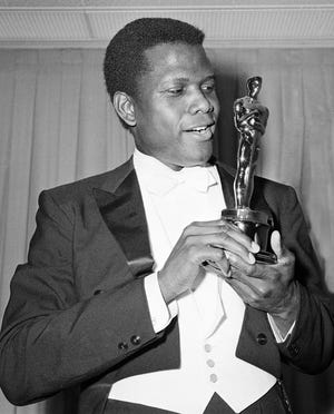Actor Sidney Poitier is photographed with his Oscar statuette at the 36th annual Academy Awards in Santa Monica, California, on April 13, 1964. He won best actor for his role in "Lillies of the Field."