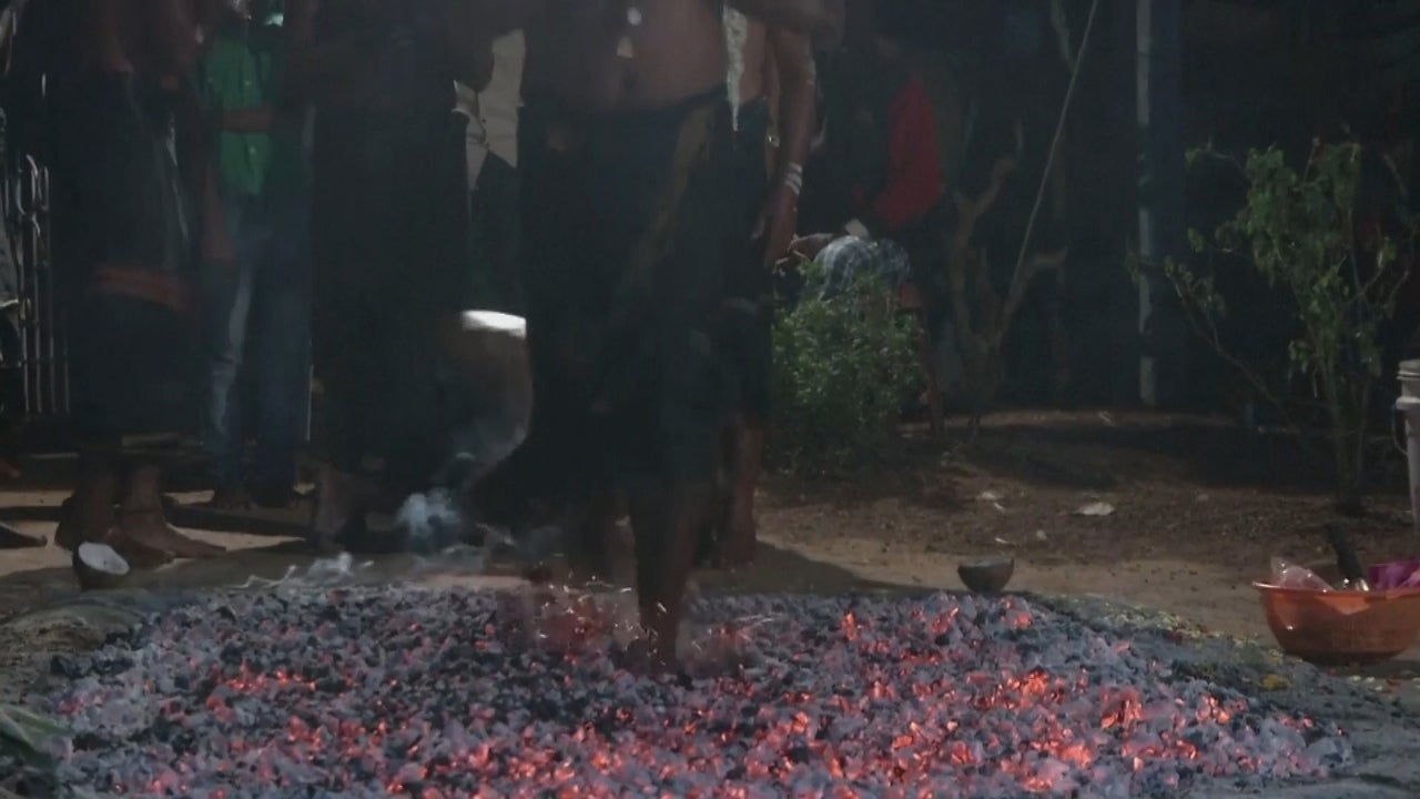 In India, Hindu devotees walk over hot Embers during a ceremony to honor Hindu God Ayyappa