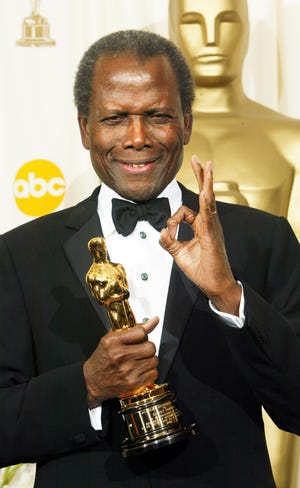 Denzel Washington presented Sidney Poitier with his honorary Oscar at the 74th annual Academy Awards on March 24, 2002.
