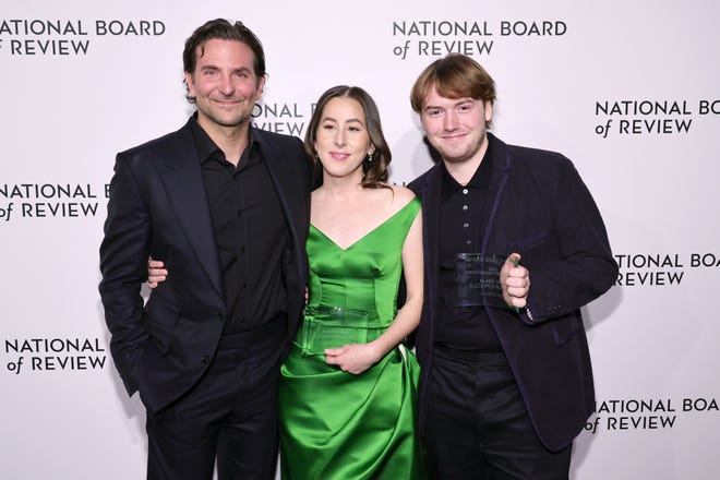 "Licorice Pizza" co-stars Bradley Cooper, left, Alana Haim and Cooper Hoffman pose on the red carpet at the annual NBR gala.