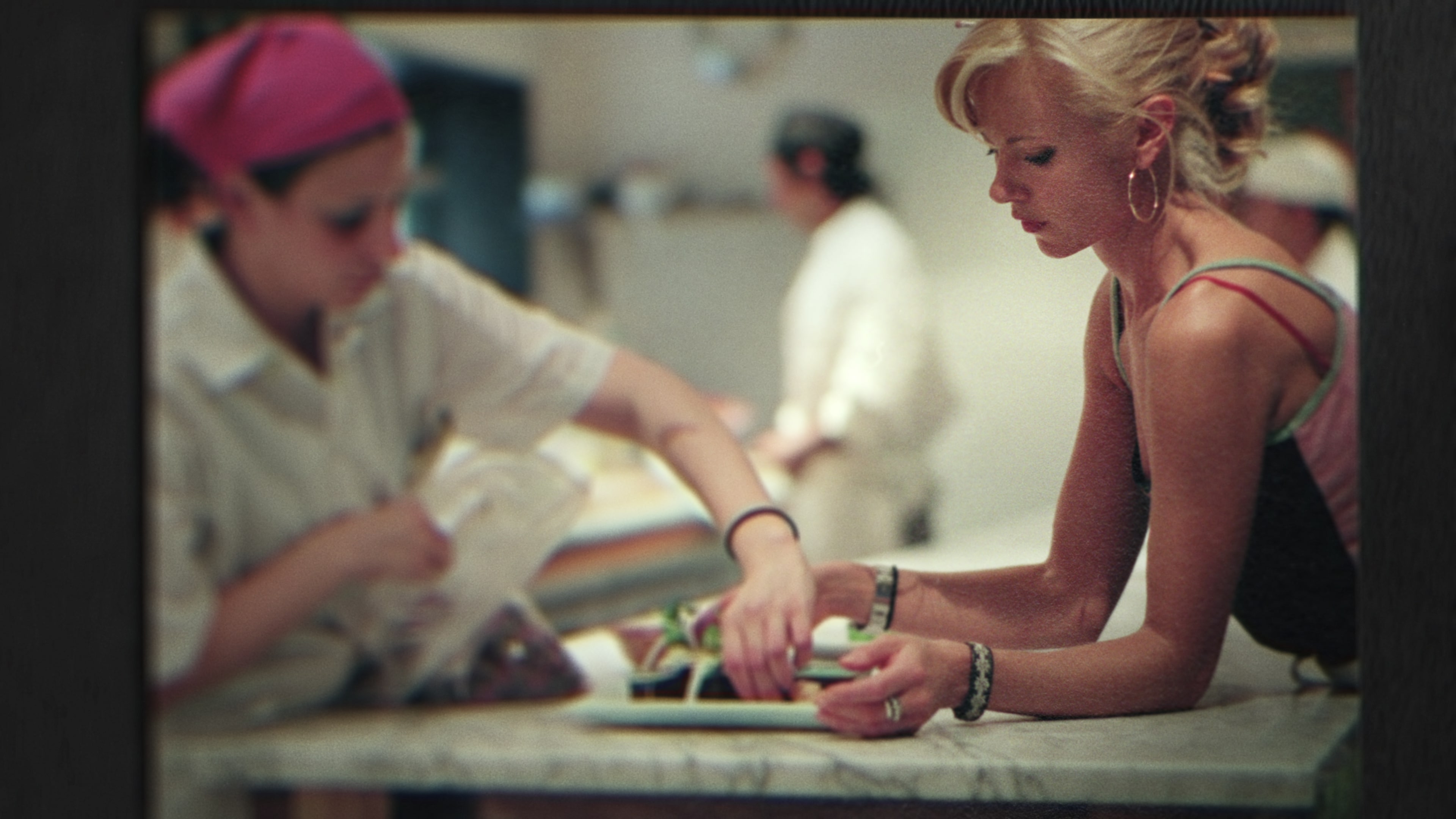 a blonde woman in a kitchen with a cook