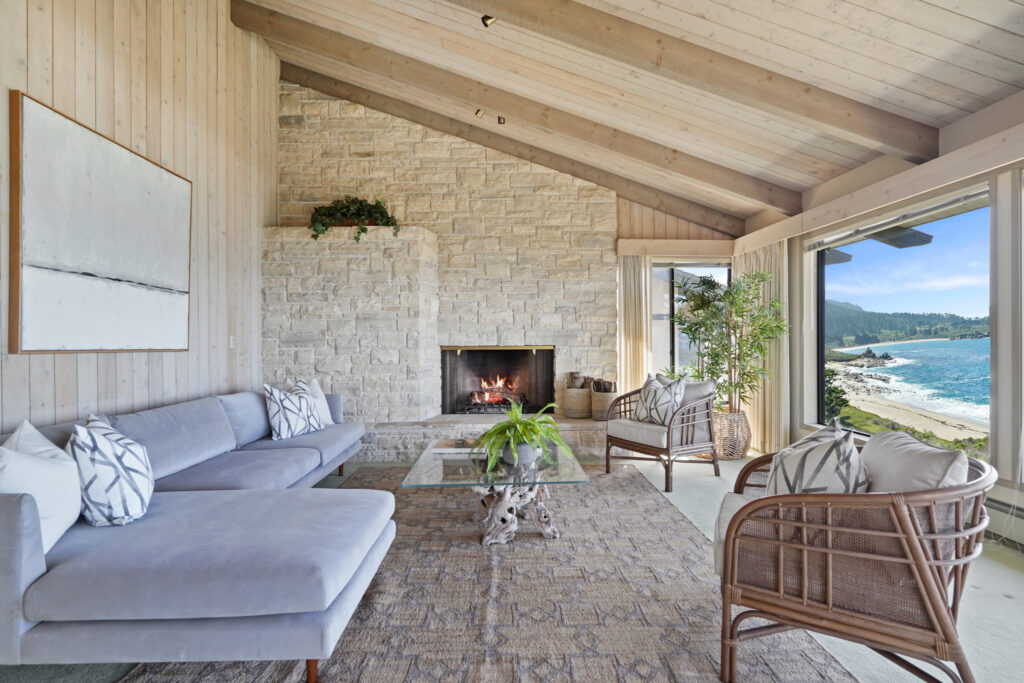 Interior shot of the living room featuring a massive stone fireplace in Betty White's Carmel-by-the-Sea home. 