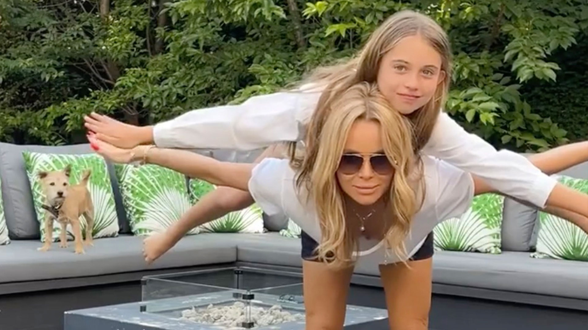 Amanda Holden shows off her toned legs and amazing tum while doing a headstand together with lookalike daughter