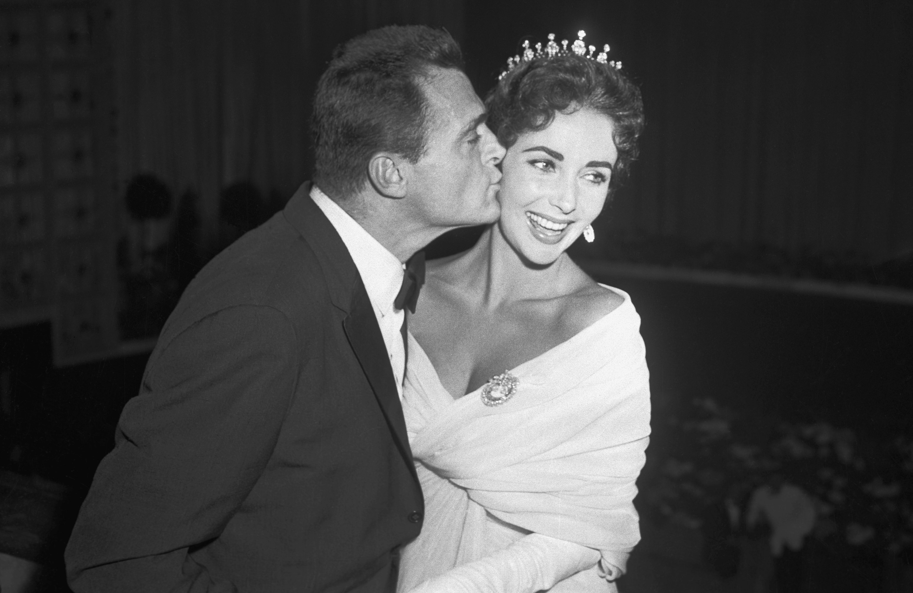 Producer Mike Todd, on top of the Cinema world, kisses his wife, actress Elizabeth Taylor, at the International Film Festival in Cannes. | Source: Getty Images