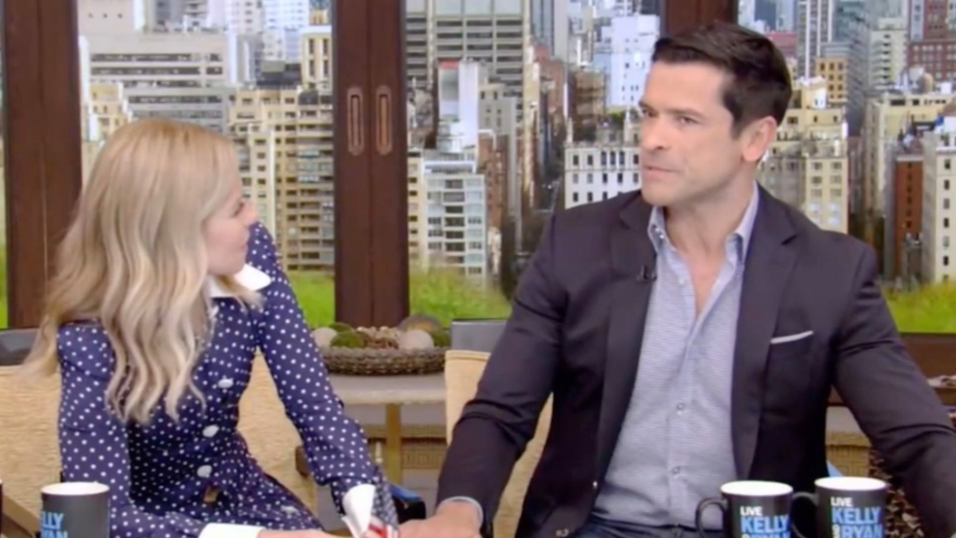 Kelly Ripa and Mark Consuelos, husband and wife, show major PDA during Ryan Seacrest’s absence on Live.