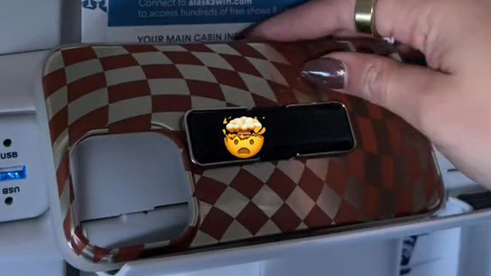 A woman discovers a clever plane seat trick that allows her to watch movies on her phone while flying