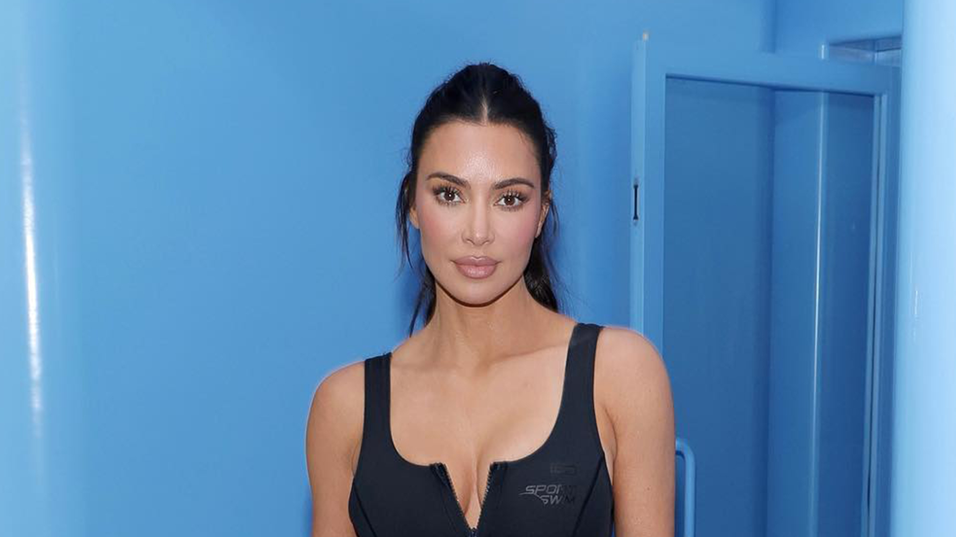 Kim Kardashian flaunts her small waist in new pictures, wearing a tight black top with baggy leather trousers