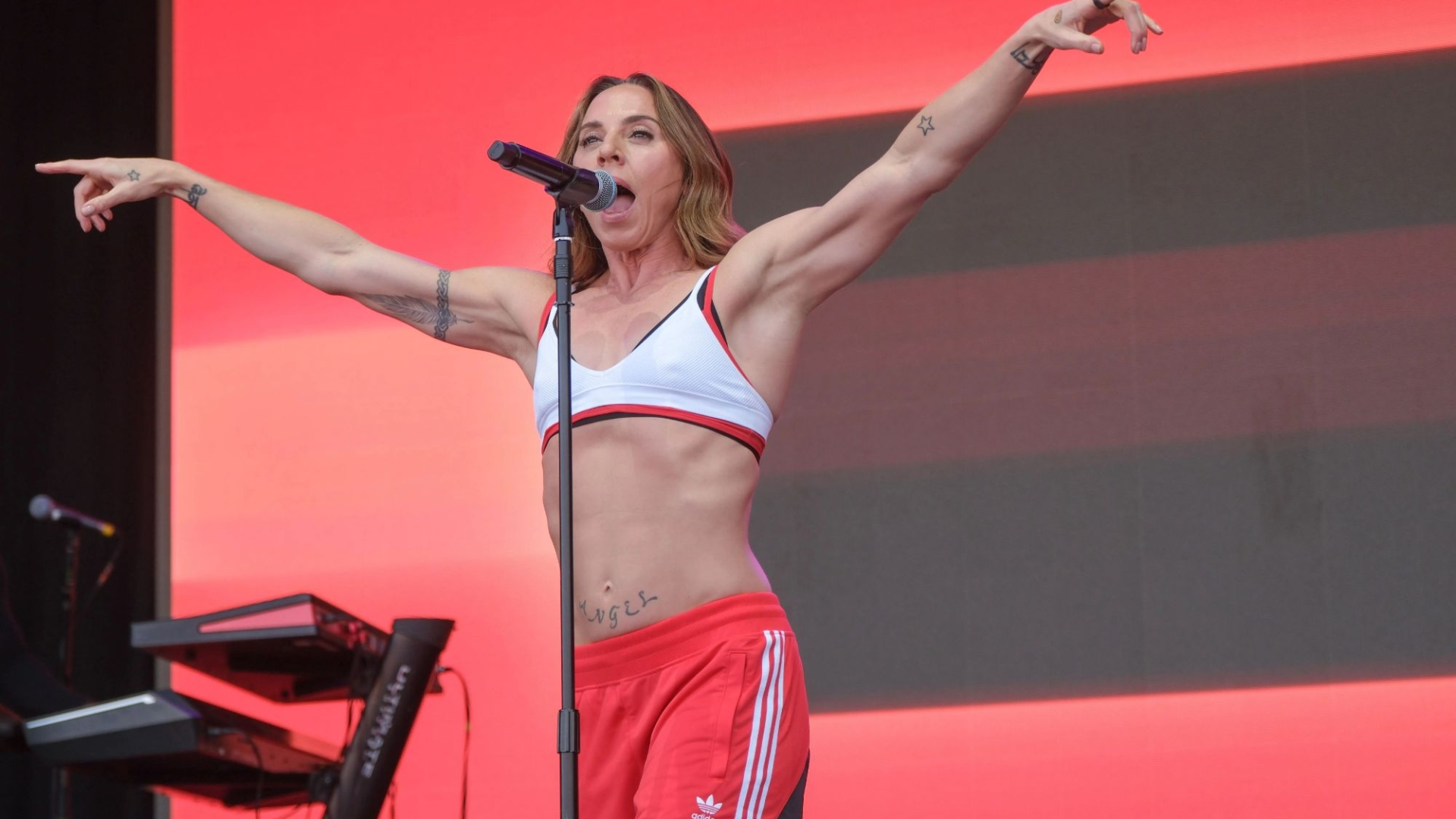 Spice Girl Mel C performs with her amazing ripped abs while wearing a sports bra