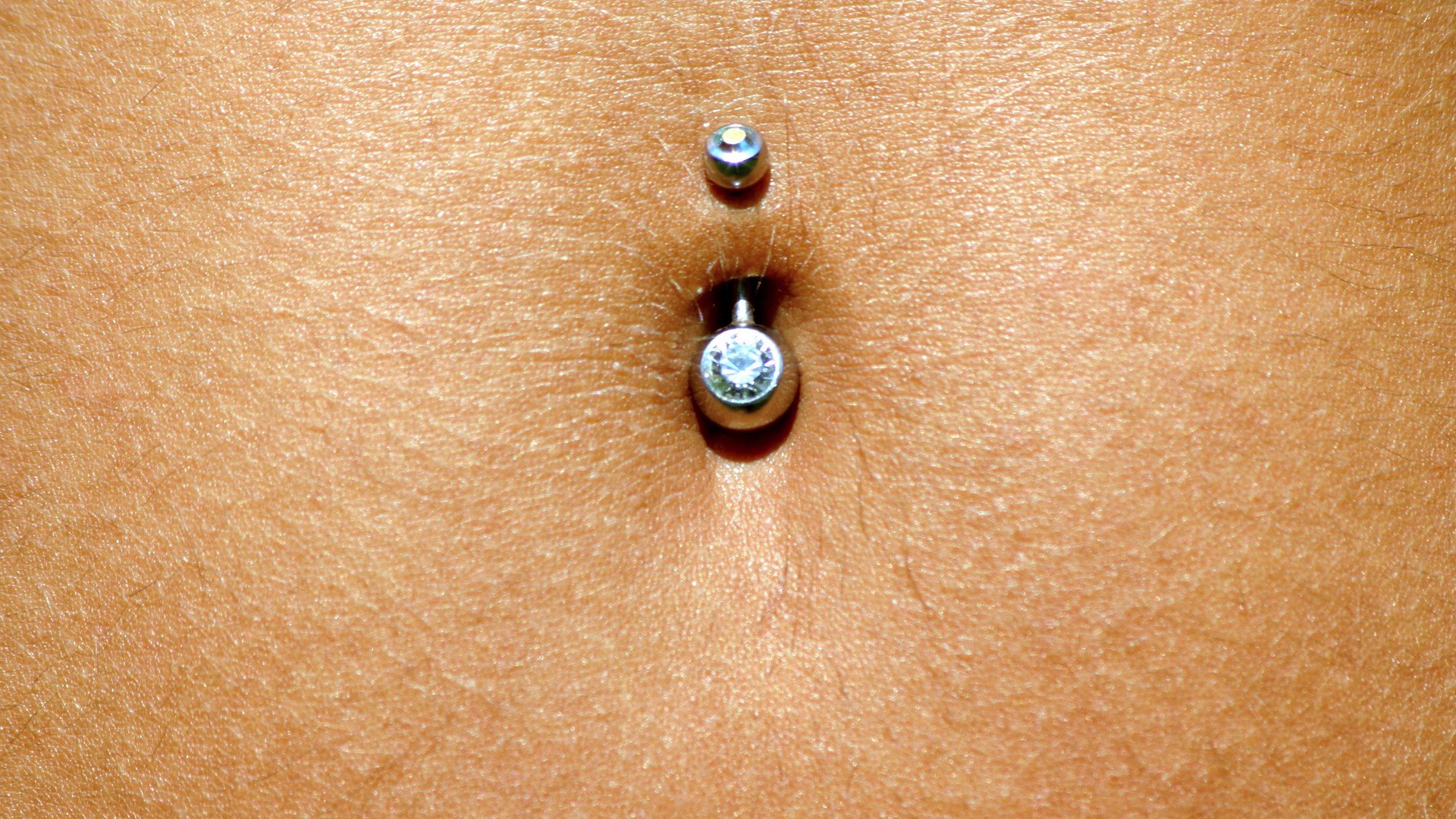 Infections, rejections and pain associated with belly button piercing