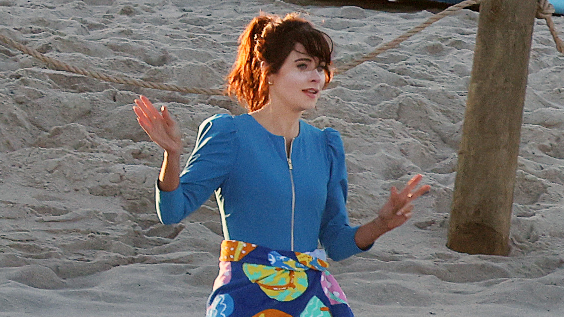 Run like Zooey Deschanel in a chic baby blue bathing suit on the beach with Charlie Cox for Merv film