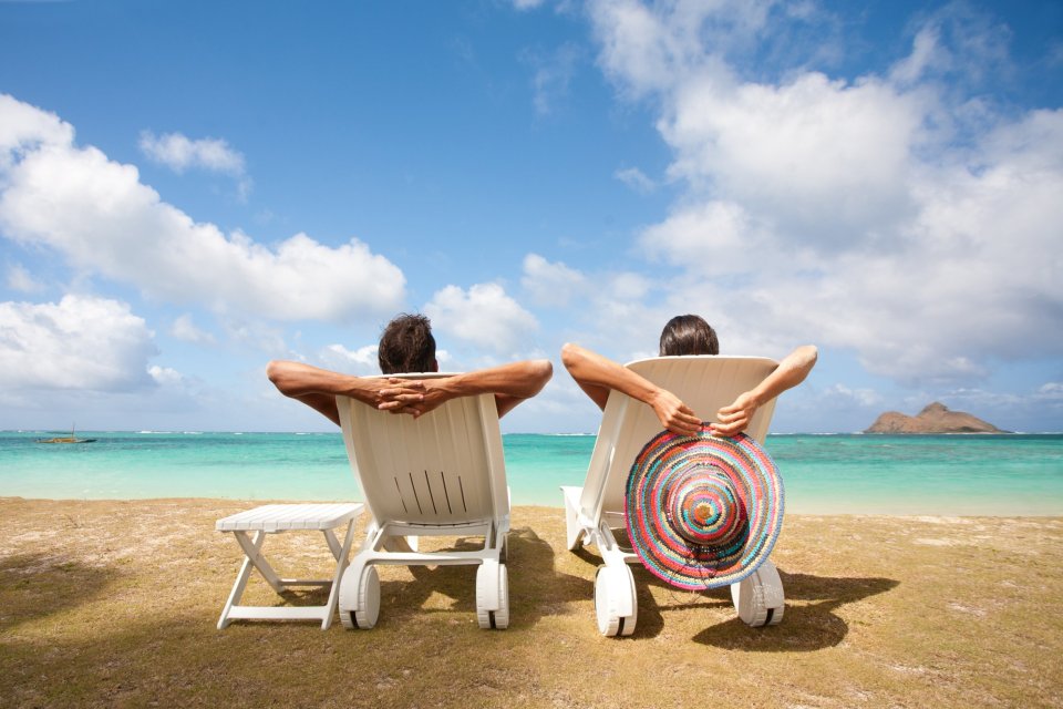 Two people lounging on the beach